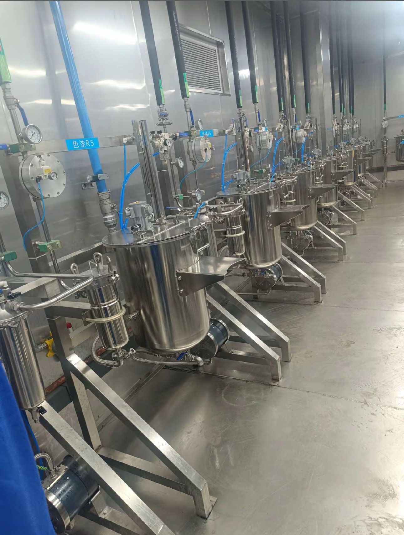 Colour stations R5 and R6 in a paint mixing room with pressure tanks, regulators and gauges mounted on the wall rail